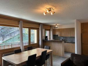 a kitchen with a wooden table and a dining room at Magrappe M 440 - SKI LIFT apartment 7 pers in Veysonnaz