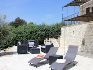 a patio with a bunch of chairs and tables at Villa in Lubéron with Saltwater Pool in Apt
