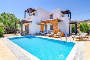 a villa with a swimming pool and a house at Villa Kiotari by Villa Plus in Kiotari