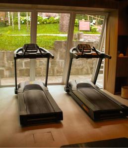 two treadmill machines sitting in front of a window at Jangal das Araucárias in Canela