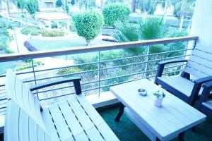 a balcony with two benches and a table and a view at kornfil guest house in New cairo