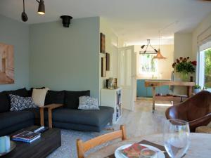 a living room with a couch and a table at Holiday Home in Noordwijk near the Beach in Noordwijk