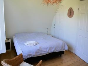 a bedroom with a bed with a blue comforter at Holiday Home in Noordwijk near the Beach in Noordwijk