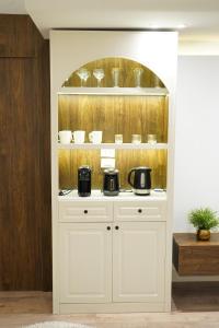 a white cabinet with two microwaves on top of it at kornfil guest house in New cairo +81 photos