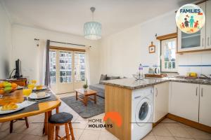 a kitchen and a living room with a table at #201 Families Only - Quinta da Flor in Vale de Pedras