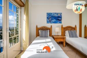 two beds in a room with a window at #201 Families Only - Quinta da Flor in Vale de Pedras +84 photos