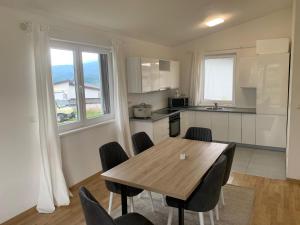 a kitchen with a wooden table and chairs in a room at منتجع سراييفو - Sarajevo Resort in Sarajevo