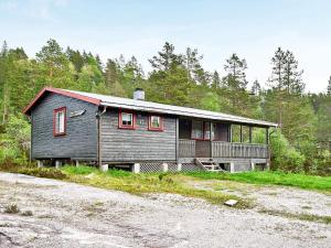 a house with red windows on the side of a road at 6 person holiday home in ÅSERAL-By Traum in Hamkoll