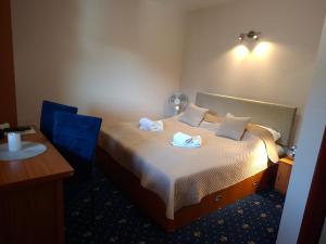 a hotel room with a bed with two towels on it at Vila Viktória in Rajecké Teplice