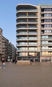 a large building with people walking in front of it at Umi in Ostend