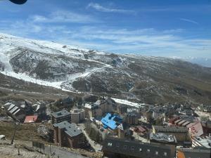 an aerial view of a town in front of a snow covered mountain at Fuente del Tesoro Apartment in Granada