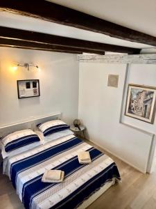 a bedroom with a bed with blue and white sheets at Summer Apartment 2 in Makarska +12 photos