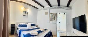 a bedroom with a bed and a flat screen tv at Summer Apartment 2 in Makarska