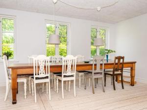 a dining room with a wooden table and chairs at 4 star holiday home in Ulfborg in Ulfborg