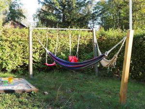 a hammock in a garden in a yard at 20 person holiday home in Ulfborg in Ulfborg