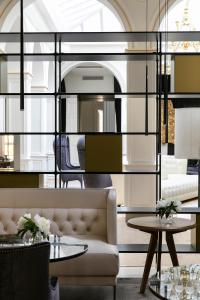 a living room with a couch and a table at Palacio de los Duques Gran Meliá - The Leading Hotels of the World in Madrid