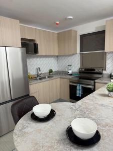a kitchen with a counter with two bowls on it at Royal's Kingston Suite 2 in Kingston