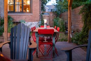 a red table and chairs on a patio at Sun-Filled Century Home in Hamilton