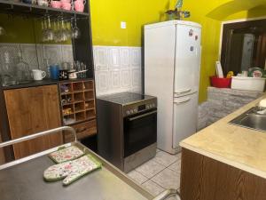 a kitchen with a refrigerator and a stove at Villa#12 in Savina