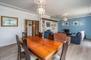 comedor y sala de estar con mesa de madera en Stunning sea view apartment in Burgau #1897, en Burgau