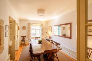 a dining room with a wooden table and chairs at Feel Discovery Casa Da Capela Douro Valley in Armamar