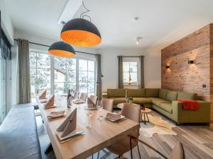 a dining room with a long table and chairs at Chalet in Alpendorf near Ski Slopes in Alpendorf