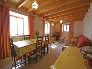 a living room with a table and chairs and a couch at Holiday Home in Esmoulières near Forest in Esmoulières