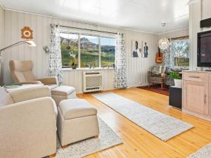 a living room with a couch and a tv at 4 star holiday home in Inndyr in Inndyr +25 photos