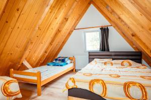a bedroom with a bed in a attic at STD Stara Vodenica in Crni Vrh