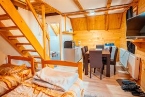 a room with a dining room and a kitchen with a table at STD Stara Vodenica in Crni Vrh