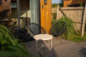 two chairs and a white chair on a deck at Letnisko Rusinowo in Jarosławiec +45 photos