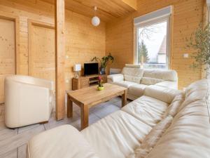 a living room with white couches and a tv at Wintersbourg Spa Retreat in Wintersbourg