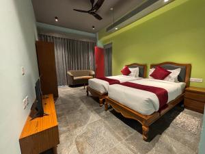 a bedroom with a bed and a television in it at Cullinan Hotel & Restaurant in Bilāspur +46 photos