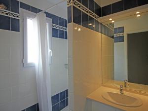 a bathroom with a sink and a mirror at Family-Friendly Villa with Pool in La Garonnette-Plage +31 photos