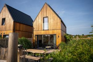 a barn conversion with a table in front of it at Letnisko Rusinowo in Jarosławiec