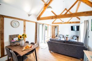 a living room with a couch and a table at Eleri's Barn in Rhayader