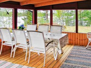 a dining room with a table and white chairs at 6 person holiday home in Vena in Vena