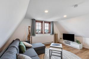 Una sala de estar con un sofá y un televisor. en Werner-Senger-Haus Limburg, en Limburg an der Lahn