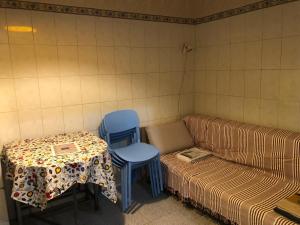 a room with a couch and two chairs and a table at Casa Fuseta-38 in Fuzeta