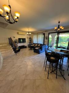 a living room with a couch and a table and chairs at Marassi سيدى عبدالرحمان in El Alamein
