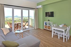 a living room with a couch and a table at 7 Grapes in Elevtheraí