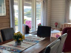 a dining room with a table and chairs and a window at 4 star holiday home in Espevær in Espevær