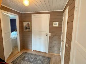 a hallway with a door and a rug at 4 star holiday home in Espevær in Espevær +27 photos