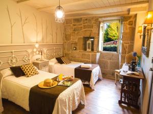 a bedroom with two beds and a table in it at Villa in A Lama near Rías Baixas Beaches in A Lama