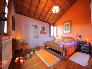 a bedroom with a bed with orange walls and candles at Villa in A Lama near Rías Baixas Beaches in A Lama