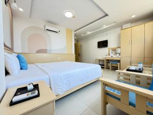 a hospital room with a bed and a table at Sea Charm Da Nang in Danang