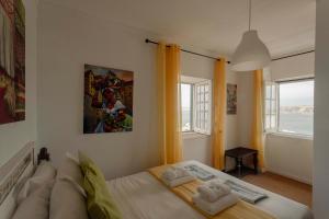 a bedroom with a bed and a large window at Best Houses 50 - Casa das Marés I - Baleal in Ferrel