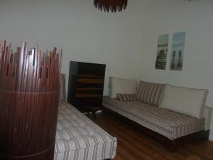 a living room with a couch and a couch and a table at Casa do Beco in Lisbon