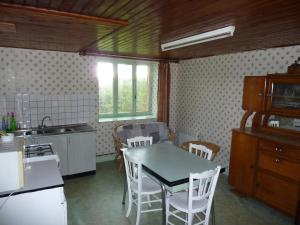 a kitchen with a table and chairs in a room at Holiday Home Vagney near Ski Gérardmer in Vagney