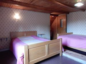 two beds in a room with pink sheets at Holiday Home Vagney near Ski Gérardmer in Vagney